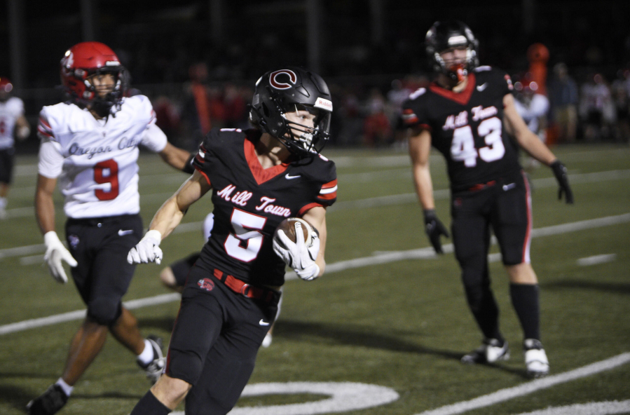 Camas’ Chase McGee turns up field for an eventual 50-yard touchdown reception as the first half clock expired in Friday’s non-league football game against Oregon City. Camas won 48-14 behind McGee’s three touchdown receptions.