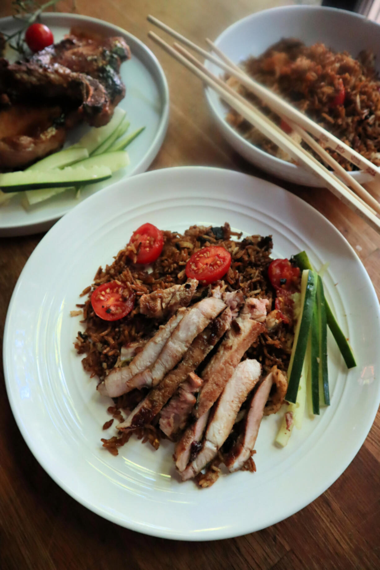 These caramelized, pan-fried pork chops are made in the same cast-iron pan as the fried rice.