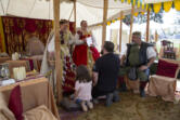 Abby Doty, 7, kneels alongside Brandon Bakemaeyer in a knighting ceremony presided over by Mary Stuart, Queen of Scots, at the 2023 Realms Unknown Fantasy Festival in Woodland. The historical reenactment group will return to this year&rsquo;s festival, which begins Friday and continues through Sunday.