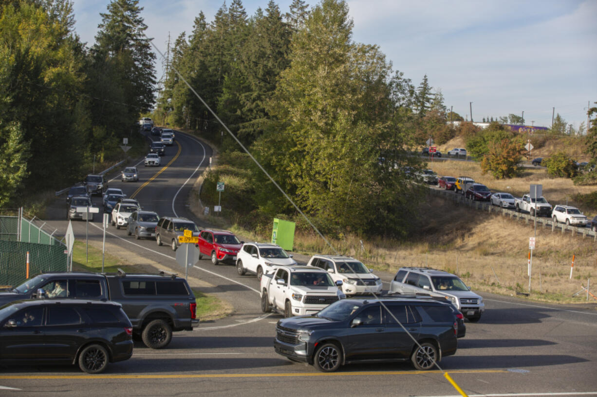 Neighborhood traffic crawls down Northeast Delfel Road while event traffic crawls down the Interstate 5 offramp at Northeast 179th Street before a Sunday concert at the RV Inn Style Resorts Amphitheater.  At top, motorists split into two lanes as they make their way along 179th Street to the amphitheater entrance for a recent Lynyrd Skynyrd/ZZ Top concert.