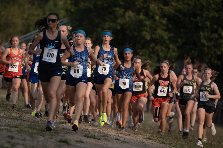 Girls varsity runners take off from the starting line during the 63rd annual Steve Maas Run-a-Ree cross country race at Hudsons Bay High School on Friday evening, Sept. 6, 2024.