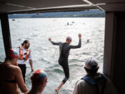 Swimmers jump off the sternwheeler Columbia Gorge at the starting line Monday, during the 80th Columbia River Cross Channel Swim in Cascade Locks, Ore.