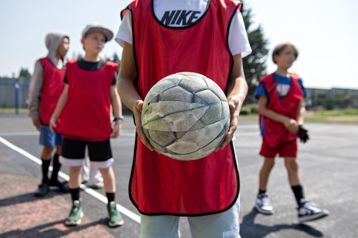 Fifth-graders at Hazel Dell Elementary School gear up for a futsal game during recess Thursday afternoon. The school has two new futsal courts.