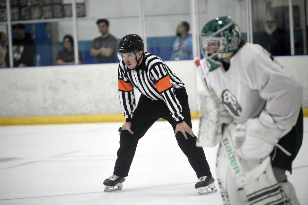 Ian Hofmann of Vancouver officiates a hockey game at the Neely Cup featuring players for the Portland Winterhawks at Sherwood Ice Arena in Sherwood, Ore., on Friday Aug. 30, 2024. Hofmann started working last year as a professional hockey official.