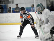 Ian Hofmann of Vancouver officiates a hockey game at the Neely Cup featuring players for the Portland Winterhawks at Sherwood Ice Arena in Sherwood, Ore., on Friday Aug. 30, 2024. Hofmann started working last year as a professional hockey official.