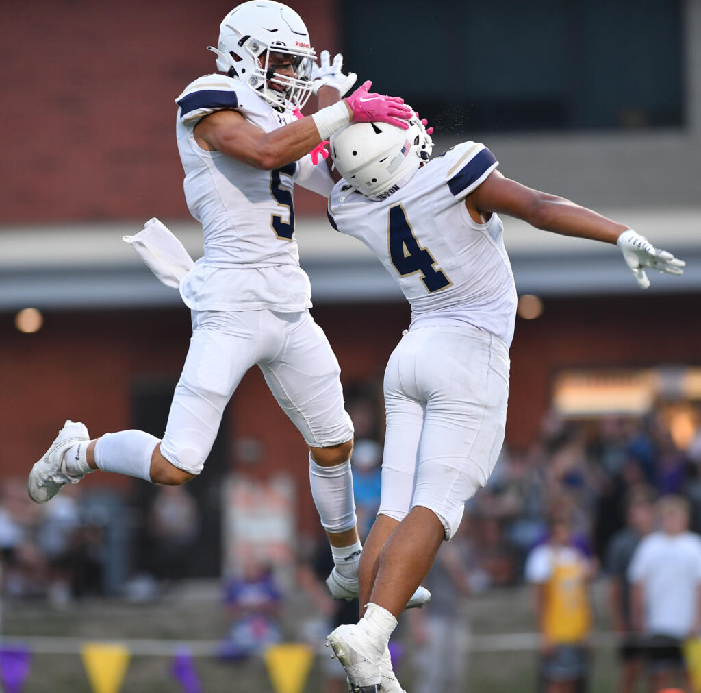 Seton Catholic seniors Ryker Ruelas (5) and Jacob Williams (4) celebrate after a touchdown Friday, Sept. 6, 2024, during Seton’s 56-7 win against Columbia River at Columbia River High School.