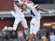 Seton Catholic seniors Ryker Ruelas (5) and Jacob Williams (4) celebrate after a touchdown Friday, Sept. 6, 2024, during Seton’s 56-7 win against Columbia River at Columbia River High School.