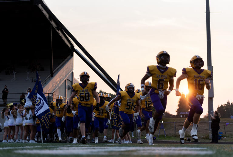 Columbia River High School players take the field Friday, Sept. 6, 2024, before a game against Seton Catholic at Columbia River High School.