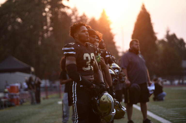 Makhi Miller (33) of Evergreen stands with his teammates for the national anthem prior to a non-league football game against Union at McKenzie Stadium on Friday, Sept. 6, 2024.