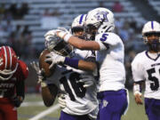 Isaiah James (16) of Heritage celebrates his interception with teammate Jacob Karpyuk during a non-league football game against Fort Vancouver at Kiggins Bowl in Vancouver on Saturday, Sept. 7, 2024.