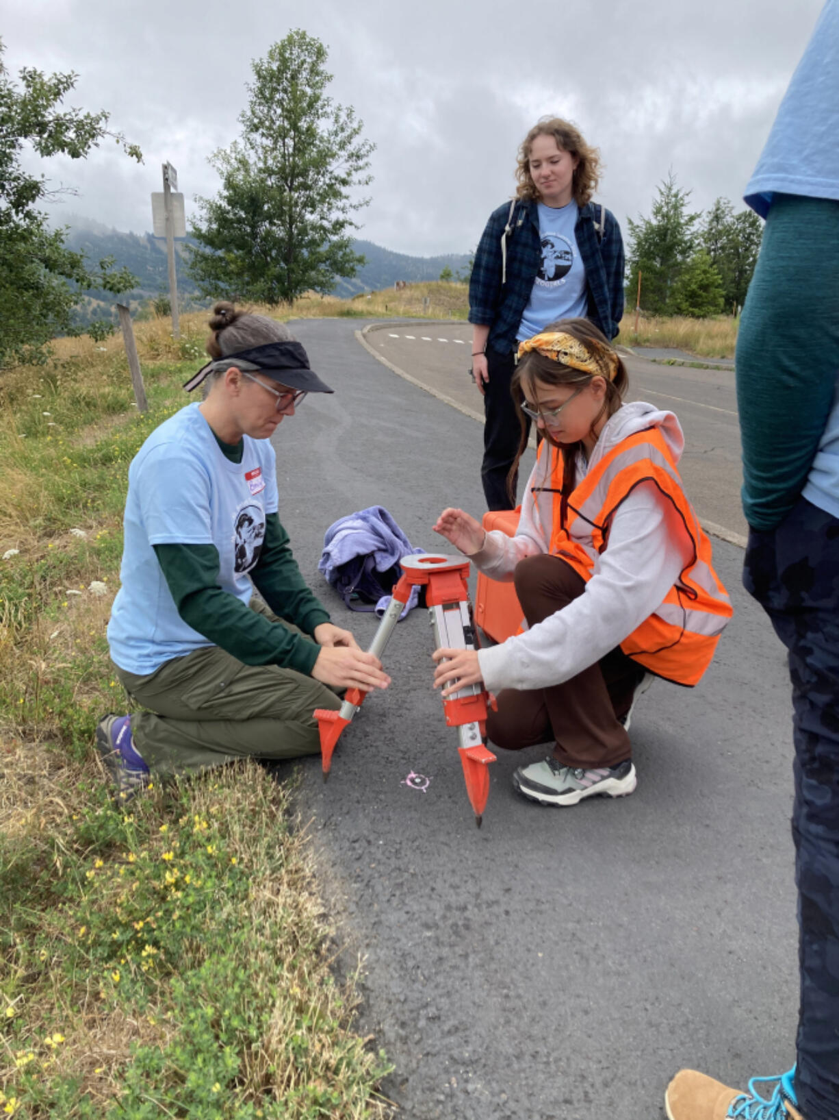 Emily Montgomery Brown, left, helps a group of students from the GeoGirls program place measuring equipment near Mount St. Helens. (Contributed by U.S.