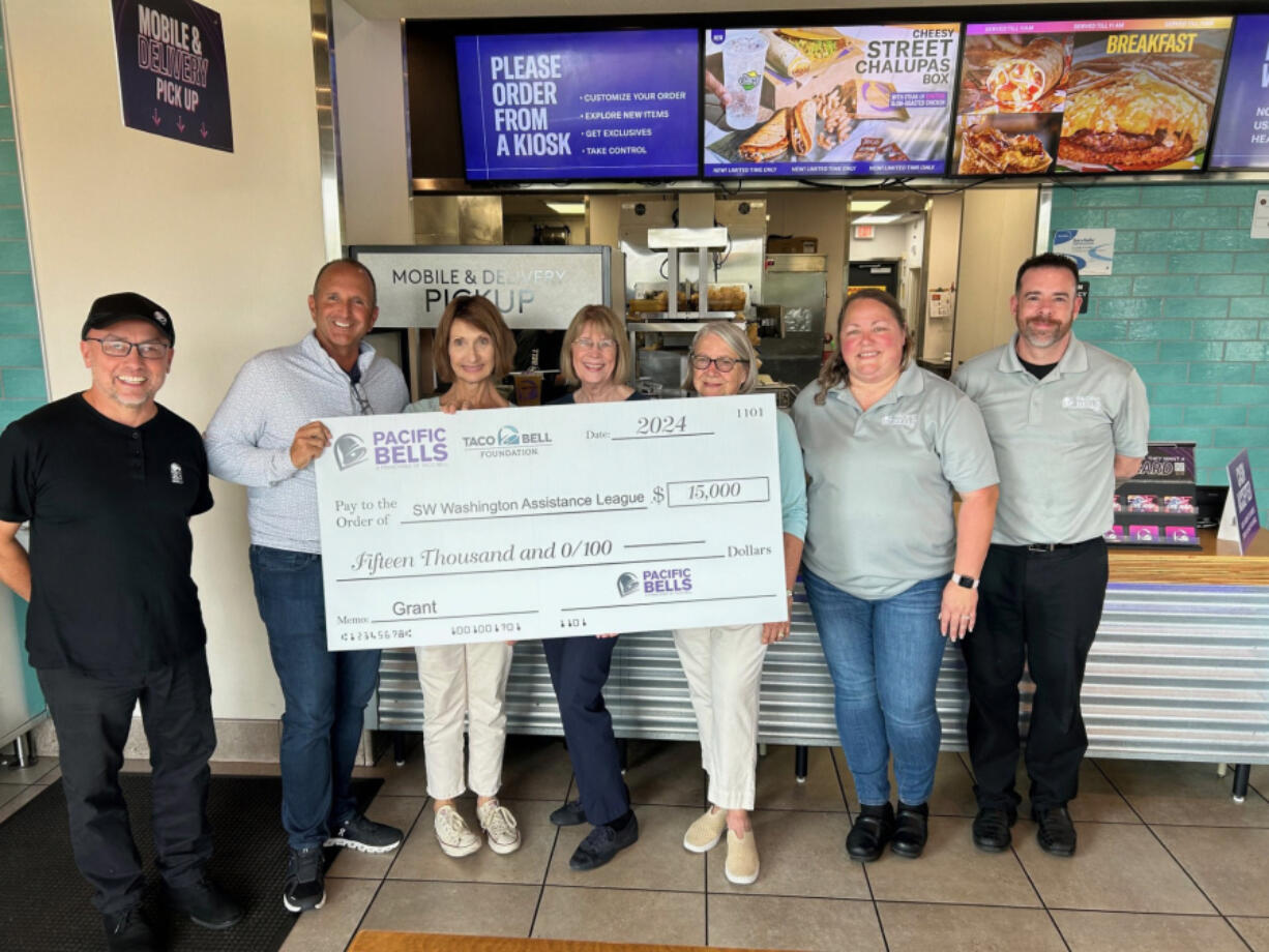 Enrique Navarro, area coach for Taco Bell, from left; Pat McKewon, vice president of Pacific Bells Taco Bell; Linda O&iacute;Leary, vice president of resource development for Assistance League Southwest Washington; Michelle Craig, Assistance League president; Jeanne Lightburn, Assistance League&rsquo;s JUST because ... chair; Angie Palacios; area coach for Taco Bell; and Kevin McKenzie, area coach for Taco Bell.