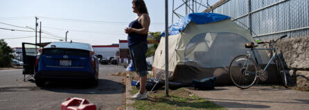 Amanda Cowan/The Columbian
Camper Becky Hoofnagle stands in the harsh sunlight while talking about the challenges of living outdoors during extreme heat in downtown Vancouver on Thursday morning. People living in their vehicles are especially vulnerable during the heat, forecasted to reach 101 degrees on Thursday.