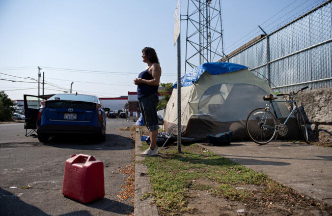 Amanda Cowan/The Columbian
Camper Becky Hoofnagle stands in the harsh sunlight while talking about the challenges of living outdoors during extreme heat in downtown Vancouver on Thursday morning. People living in their vehicles are especially vulnerable during the heat, forecasted to reach 101 degrees on Thursday.