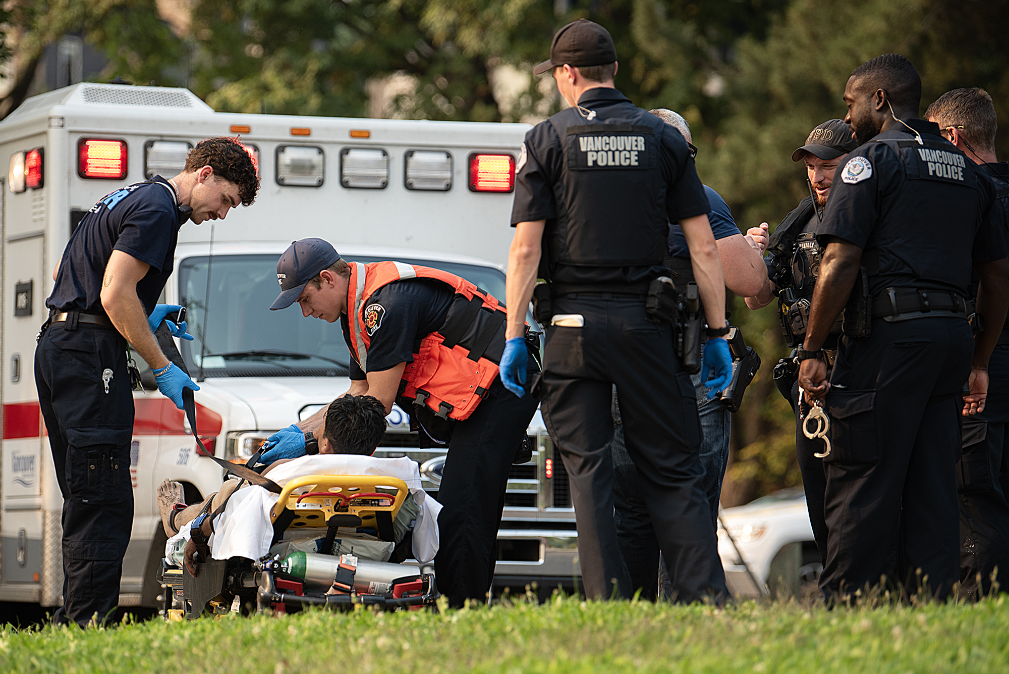 First responders work under nearly triple-digit heat during an excessive heat warning as they restrain a swimmer having a mental health episode at Wintler Park on Thursday afternoon, Sept. 5, 2024.