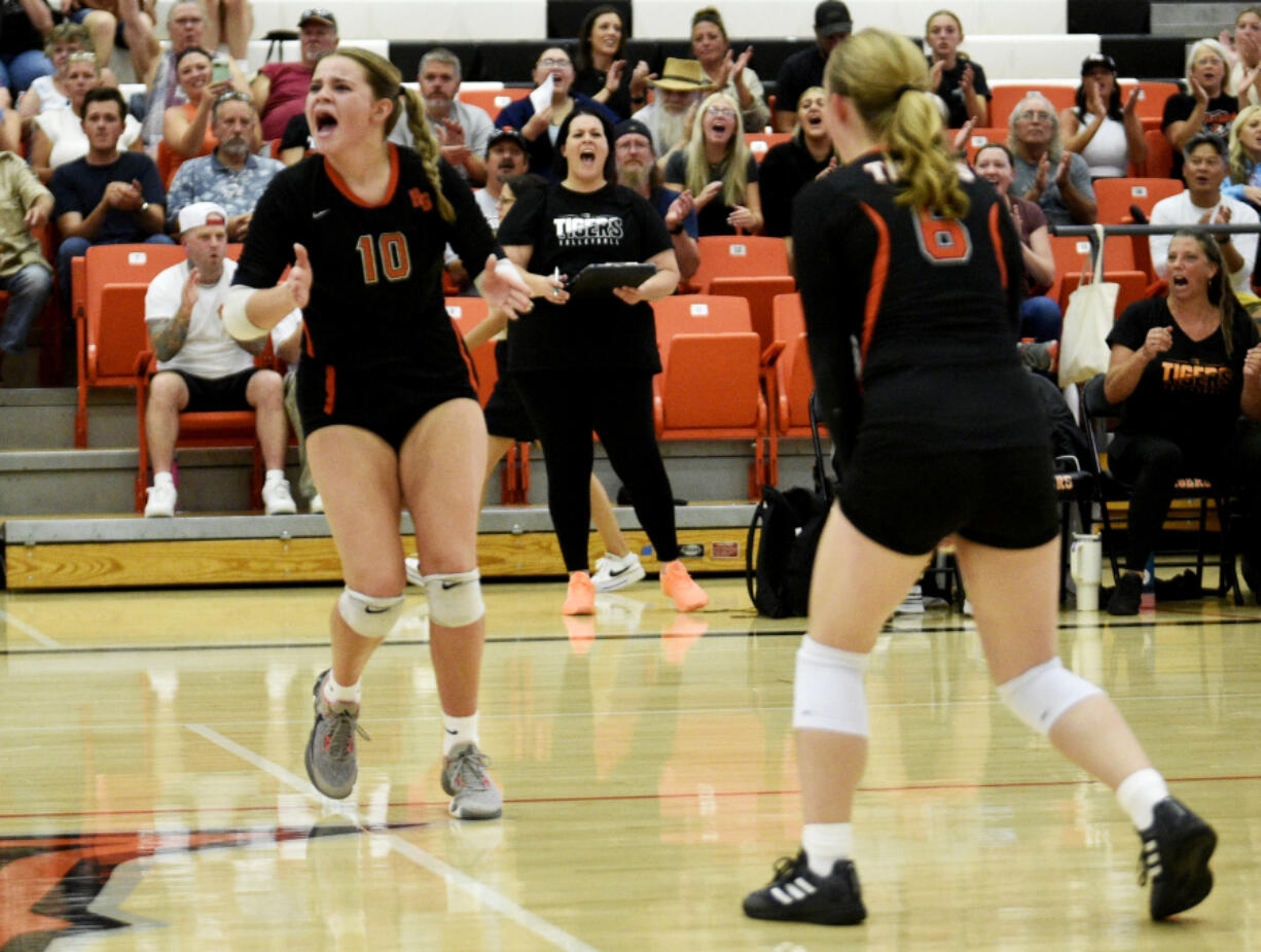 Battle Ground volleyball coach Dana Snodgrass, center, cheers as players Savannah Snodgrass (10) and Lilly Sappington (6) celebrate a point during a season-opening match against Hudson&rsquo;s Bay on Wednesday, Sept. 4, 2024 at Battle Ground High School.