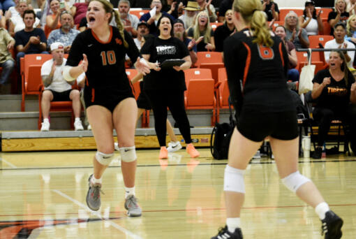 Battle Ground volleyball coach Dana Snodgrass, center, cheers as players Savannah Snodgrass (10) and Lilly Sappington (6) celebrate a point during a season-opening match against Hudson&rsquo;s Bay on Wednesday, Sept. 4, 2024 at Battle Ground High School.