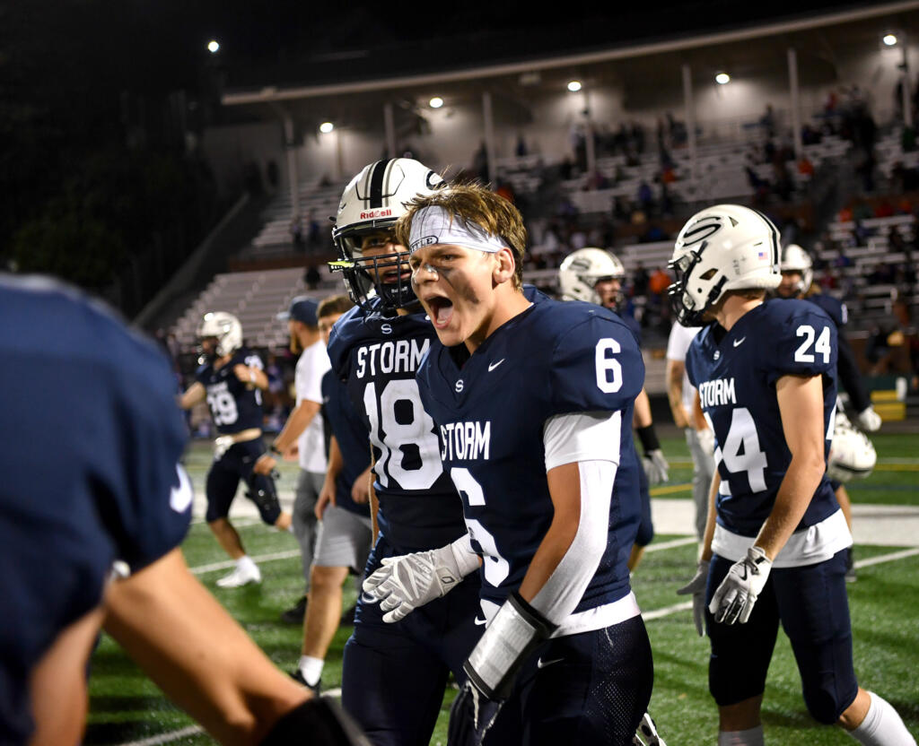 Skyview senior Matt Glaus (6) celebrates with teammates Friday, Sept. 13, 2024, after the Storm’s 21-17 comeback win against Graham-Kapowsin at Kiggins Bowl.