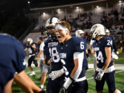 Skyview senior Matt Glaus (6) celebrates with teammates Friday, Sept. 13, 2024, after the Storm’s 21-17 comeback win against Graham-Kapowsin at Kiggins Bowl.