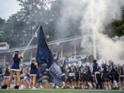 Skyview High School’s football team storms the field Friday, Sept. 13, 2024, before their game against Graham-Kapowsin at Kiggins Bowl.