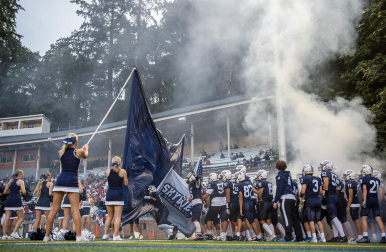 Skyview High School’s football team storms the field Friday, Sept. 13, 2024, before their game against Graham-Kapowsin at Kiggins Bowl.