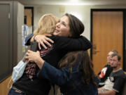 Debbie Akers of Recovery Cafe, left, shares a hug with Clark County Superior Court Adult Drug Court graduate Jennifer Miller on Thursday before Miller speaks to the group at the Clark County Courthouse. Superior Court is celebrating 25 years of hosting a drug court, which allows those who graduate the treatment court to have their criminal cases dismissed.