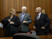 Clark County Superior Court Judge Christine Hayes, left, smiles with father Jay Hayes, center, and husband Ryan Busby on Friday during her swearing-in ceremony at the Clark County Courthouse. Gov. Jay Inslee appointed Hayes to fill the newly created 12th Superior Court judicial department.