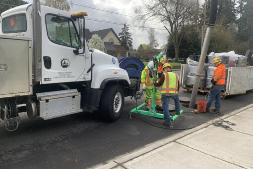 A Clark County Public Works crew replaces filter cartridges in an underground vault on Hazel Dell Avenue. Public Works&rsquo; clean water division is proposing new stormwater rates to keep pace with required services.