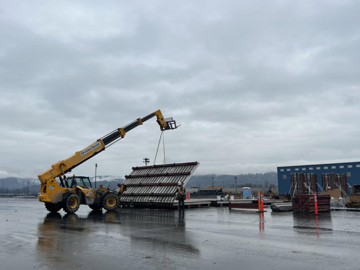 Crews work to build a wood pellet production facility in February at the Port of Longview. The goal of the UK-based company is to ship pellets to Asia, where they would be burned for energy.