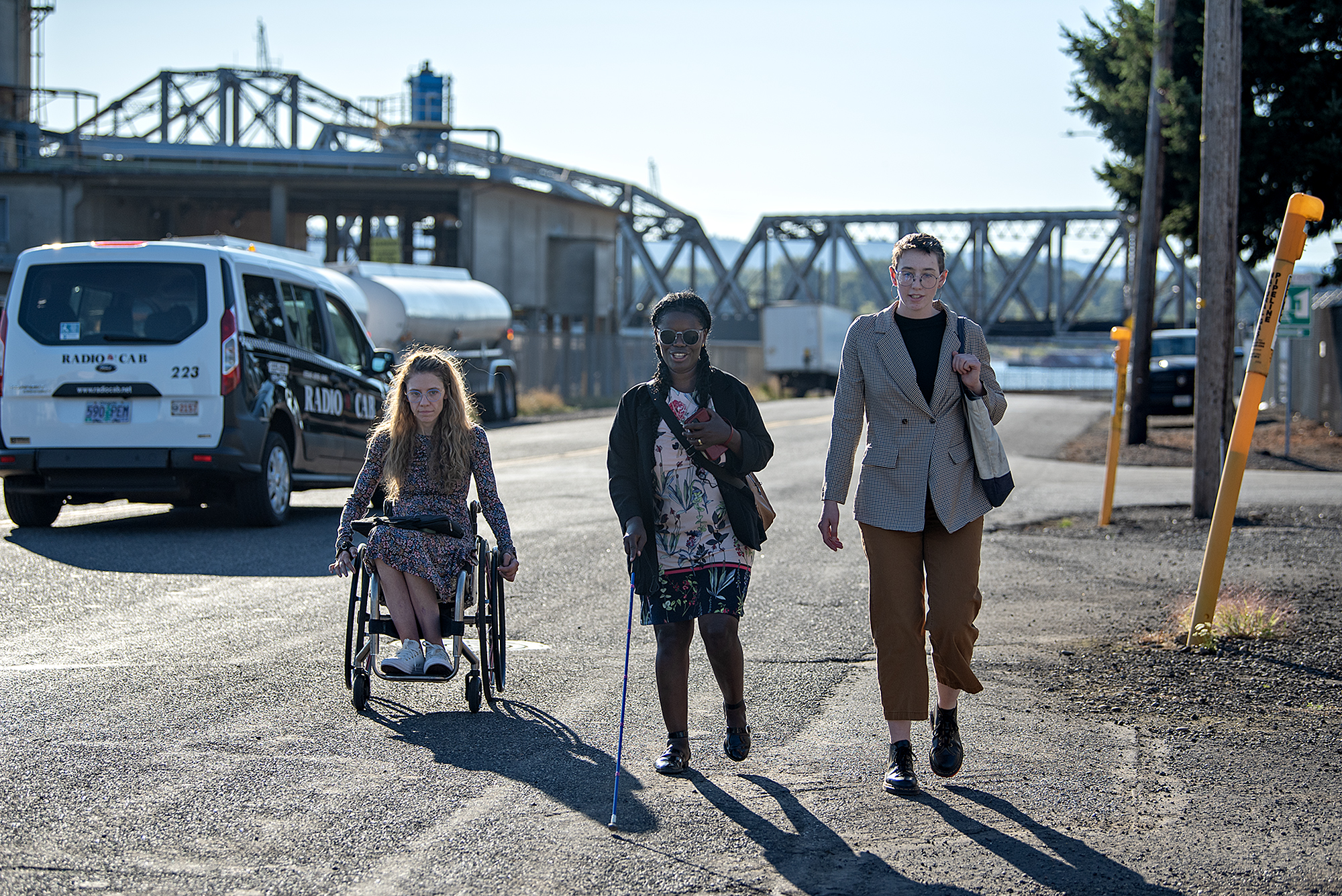 Cecelia Black of Seattle, from left, joins Vancouver resident Abby Griffith and Kail Hibbs of the City of Vancouver as they navigate a stretch of road without sidewalks after leaving the Vancouver train station on Monday afternoon, Sept. 17, 2024. The journey was held in support of the city’s Week Without Driving Proclamation to highlight the importance of mobility access in the region.