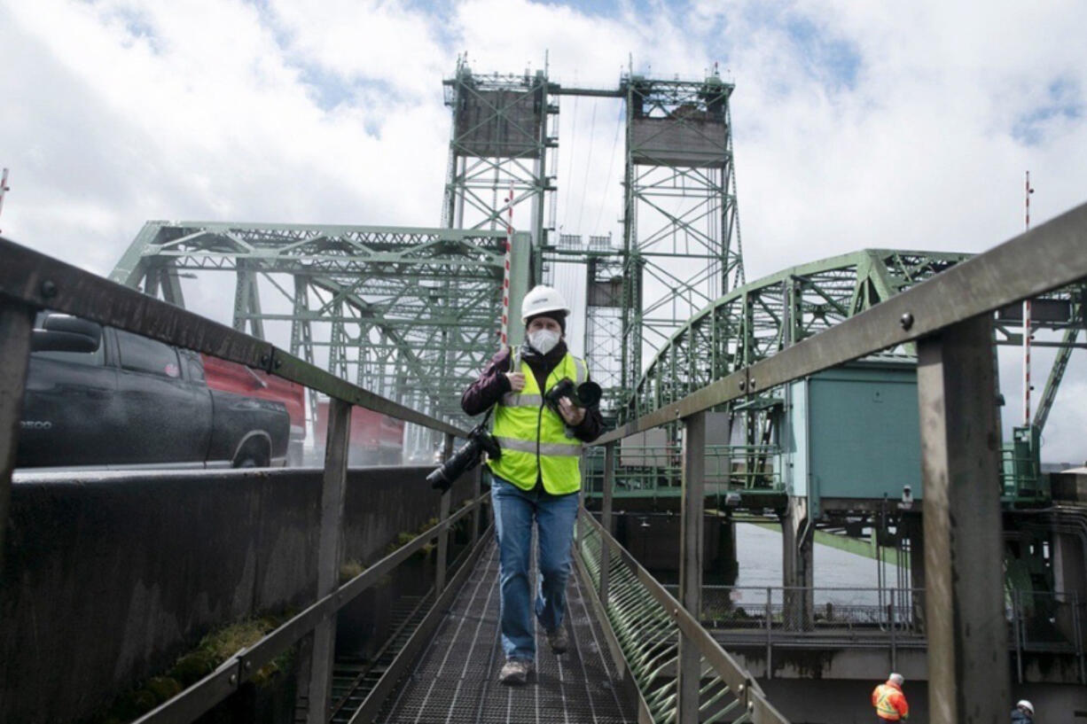 Amanda Cowan, photographer and photo editor at The Columbian, works during a tour of the Interstate Bridge in 2022.