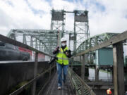 Amanda Cowan, photographer and photo editor at The Columbian, works during a tour of the Interstate Bridge in 2022.