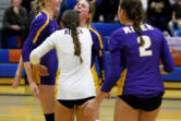 Columbia River's Sydney Dreves, left, celebrates a point with teammates during a Class 2A Greater St. Helens League volleyball match against Ridgefield on Tuesday, Sept. 17, 2024 at Ridgefield High School.