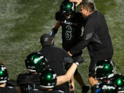 Woodland head coach Glen Flanagan, right, pats junior Josiah Graham (8) on the head after Graham intercepted a pass Friday, Sept. 20, 2024, during Woodland’s 12-0 win against Washougal at Woodland High School.