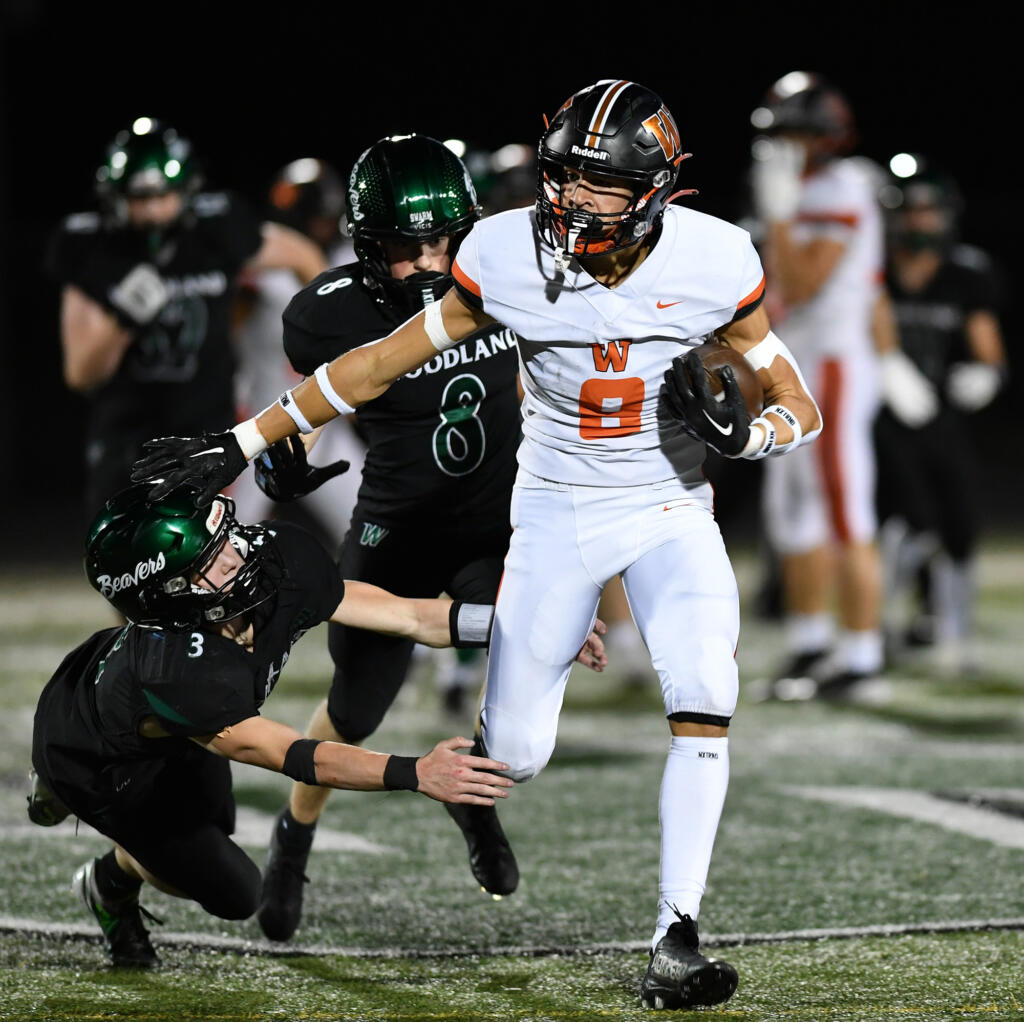 Washougal junior Royce Jones (8) stiff arms would-be tackler Woodland junior Karsen Northcut (3) on Friday, Sept. 20, 2024, during Washougal’s 12-0 loss to Woodland at Woodland High School.