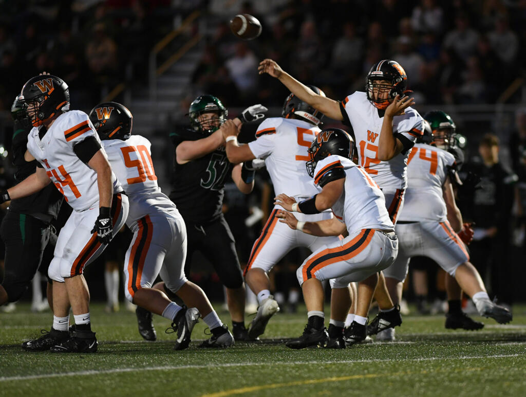 Washougal senior Kaden Fautt (12) throws the ball Friday, Sept. 20, 2024, during Washougal’s 12-0 loss to Woodland at Woodland High School.