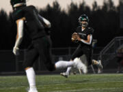 Woodland senior Elijah Andersen (4) looks for an open receiver Friday, Sept. 20, 2024, during Woodland’s 12-0 win against Washougal at Woodland High School.