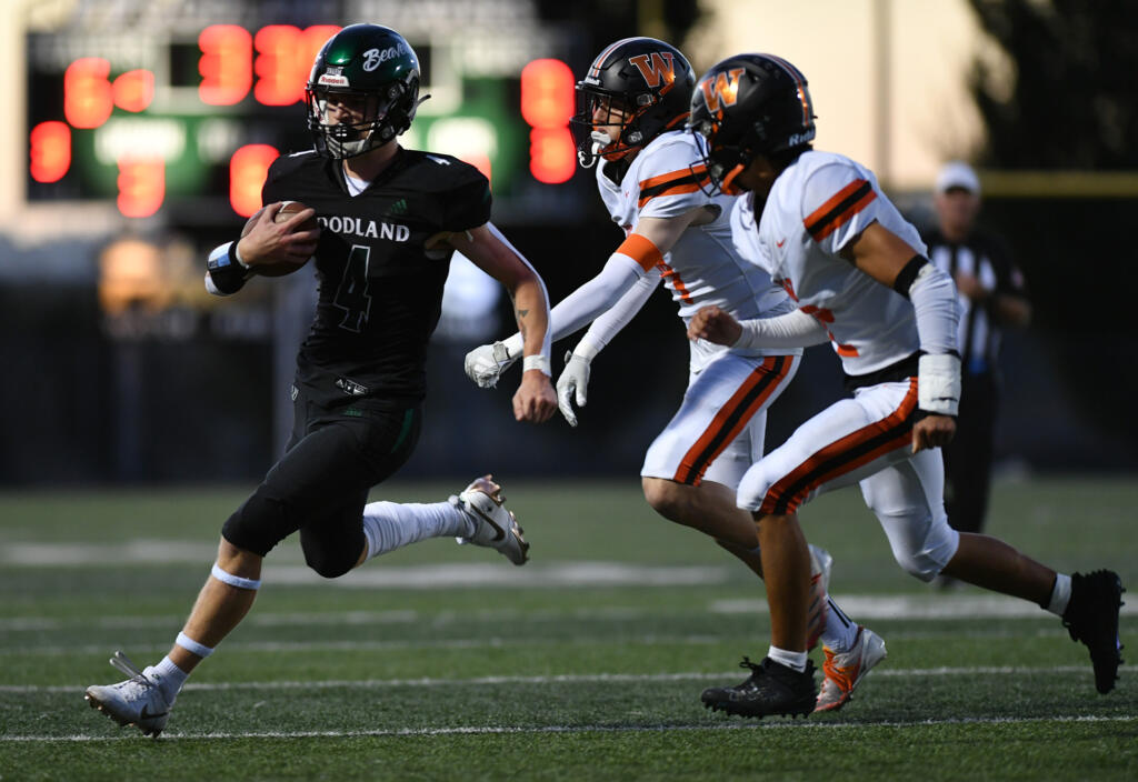 Woodland senior Elijah Andersen (4) scrambles for a first down Friday, Sept. 20, 2024, during Woodland’s 12-0 win against Washougal at Woodland High School.