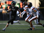 Woodland senior Elijah Andersen (4) scrambles for a first down Friday, Sept. 20, 2024, during Woodland’s 12-0 win against Washougal at Woodland High School.