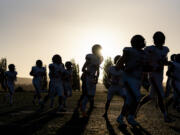 Washougal players run to the locker room Friday, Sept. 20, 2024, before a game against Woodland at Woodland High School.