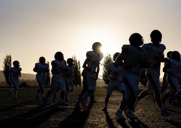 Washougal players run to the locker room Friday, Sept. 20, 2024, before a game against Woodland at Woodland High School.