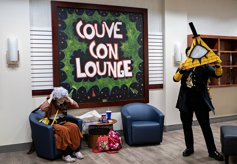 Hex Soman of Portland, left, takes a break in the Couve Con Lounge while dressed as Ink Sans.  Grimm Valentine, also of Portland, channels the character Bill Cipher at Vancouver Mall on Saturday afternoon.