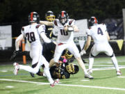 R.A. Long quarterback Jaxson Rivenes (10) spins out of a tackle against Hudson's Bay in a 2A Greater St. Helens League football game at Kiggins Bowl on Friday, Sept. 20, 2024.