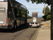 A bus travels past a speed sign on East Evergreen Boulevard. When the sign was placed in the area last week, it mistakenly displayed &ldquo;ticket sent&rdquo; to speeders.