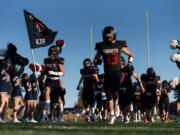 The King’s Way Knights take the field Friday, Sept. 27, 2024, before a game against La Center at King’s Way Christian School.