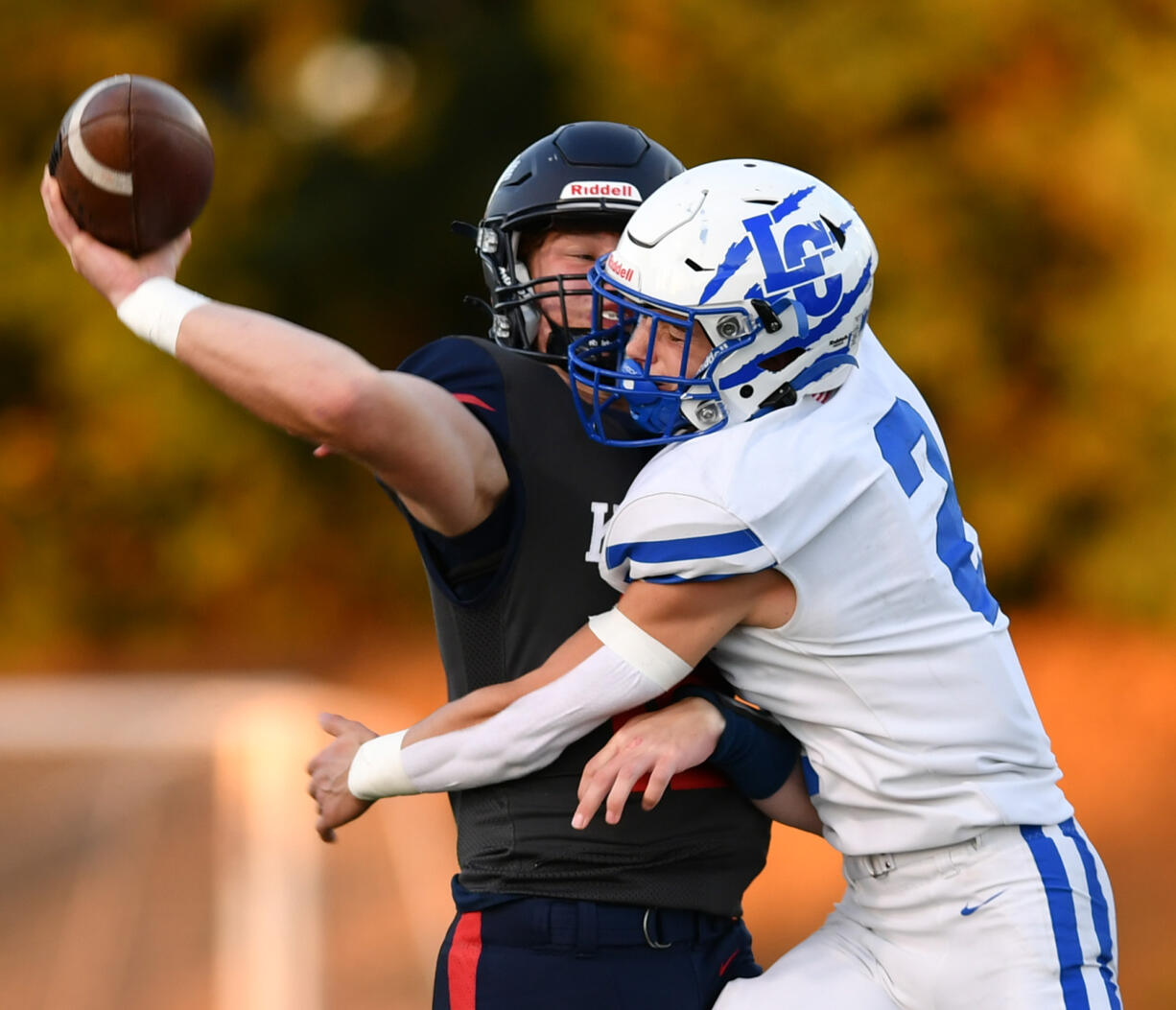 La Center junior Gaven Emerson (2) crashes into King’s Way sophomore Owen Paulsen as Paulsen throws the ball Friday, Sept. 27, 2024, during La Center’s 34-0 win against King’s Way at King’s Way Christian School.