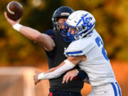 La Center junior Gaven Emerson (2) crashes into King’s Way sophomore Owen Paulsen as Paulsen throws the ball Friday, Sept. 27, 2024, during La Center’s 34-0 win against King’s Way at King’s Way Christian School.