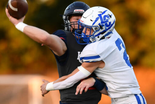 La Center junior Gaven Emerson (2) crashes into King’s Way sophomore Owen Paulsen as Paulsen throws the ball Friday, Sept. 27, 2024, during La Center’s 34-0 win against King’s Way at King’s Way Christian School.