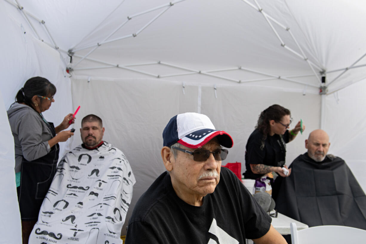 Stylists with Shear Luck keep veterans looking good as they offer haircuts to participants at the annual Stand Down resource event at the Armed Forces Reserve Center on Friday afternoon.