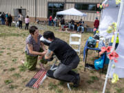 Volunteer Sarah Peterson of Self Balance Massage works with a participant during the annual Stand Down resource event at the Armed Forces Reserve Center on Friday afternoon.